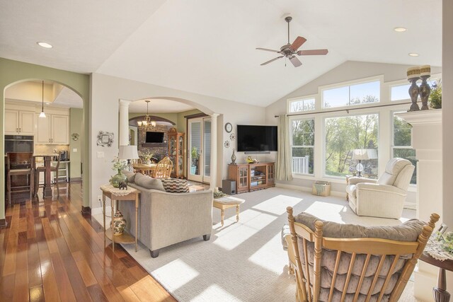 living room with ceiling fan, arched walkways, high vaulted ceiling, wood-type flooring, and recessed lighting