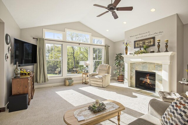 carpeted living room featuring a tiled fireplace, a ceiling fan, recessed lighting, and high vaulted ceiling