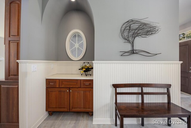 interior space featuring a wainscoted wall and arched walkways