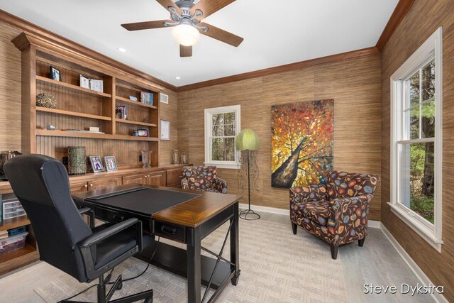 office space with crown molding, baseboards, a ceiling fan, and visible vents