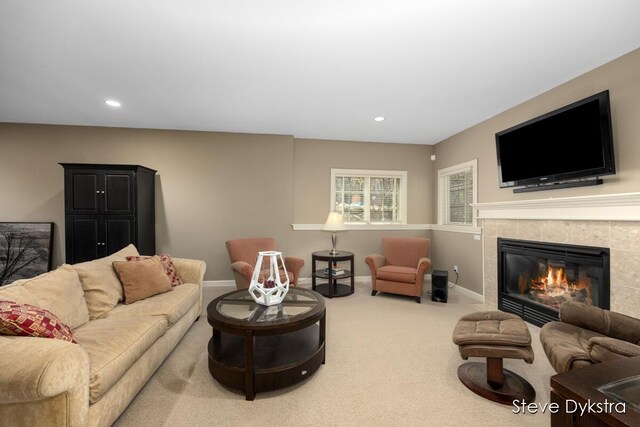 carpeted living area with recessed lighting, baseboards, and a fireplace