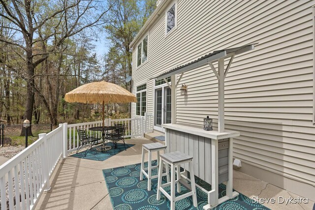 view of patio featuring outdoor dining area and a deck