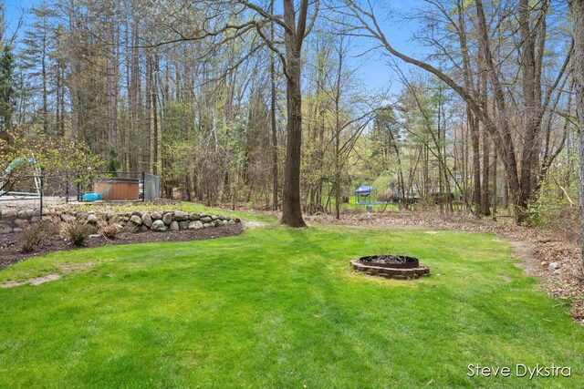 view of yard with an outdoor fire pit