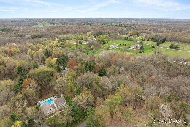 birds eye view of property with a view of trees