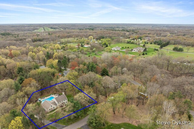 birds eye view of property with a wooded view