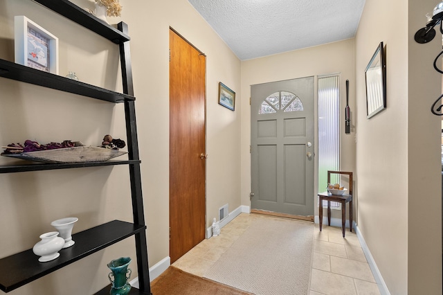 3529 E Lemon Creek Rd, Berrien Springs, MI 49103 - foyer entrance featuring a textured ceiling, baseboards, and light tile patterned floors