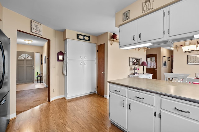 3529 E Lemon Creek Rd, Berrien Springs, MI 49103 - kitchen with light wood-style flooring, white cabinets, and baseboards