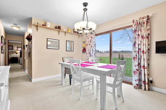 3529 E Lemon Creek Rd, Berrien Springs, MI 49103 - dining space with a chandelier, light carpet, and baseboards