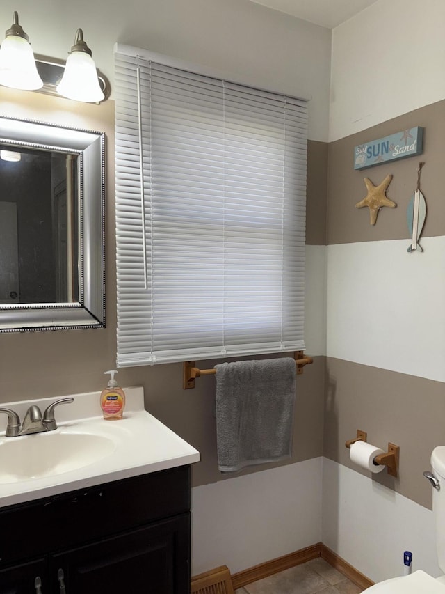 half bathroom with toilet and vanity