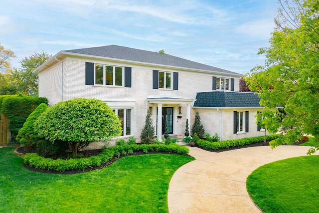 view of front of property with brick siding and a front yard