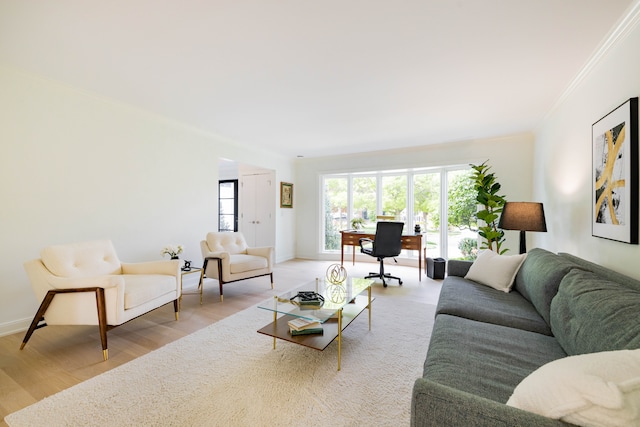 living area with crown molding, wood finished floors, an office area, and baseboards