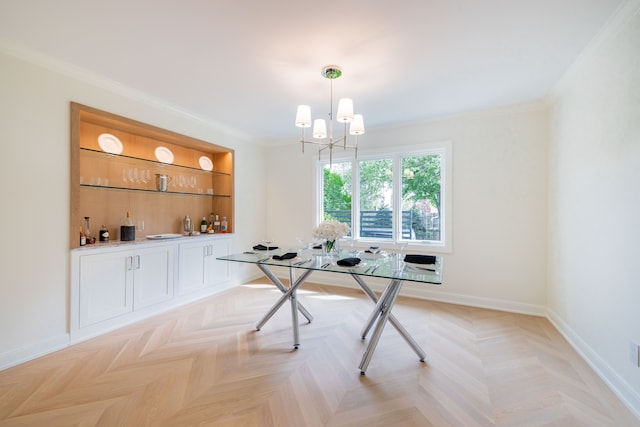dining space with a chandelier, ornamental molding, and baseboards