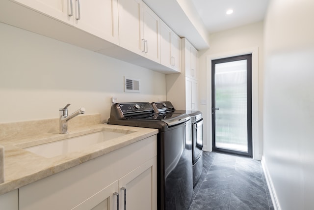 clothes washing area with washing machine and clothes dryer, cabinet space, recessed lighting, and baseboards