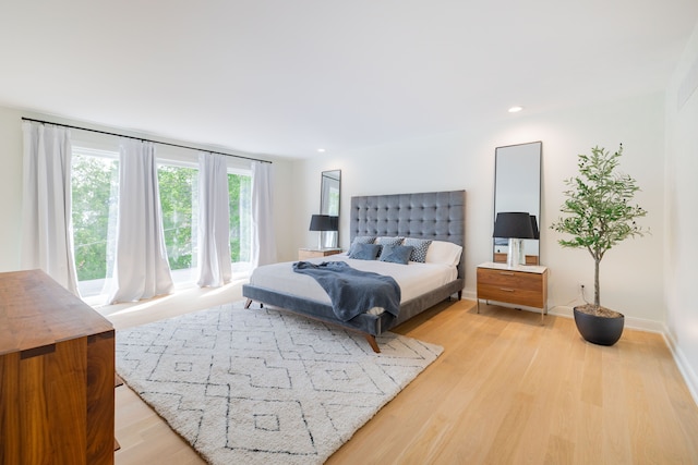 bedroom with light wood-style floors, recessed lighting, and baseboards