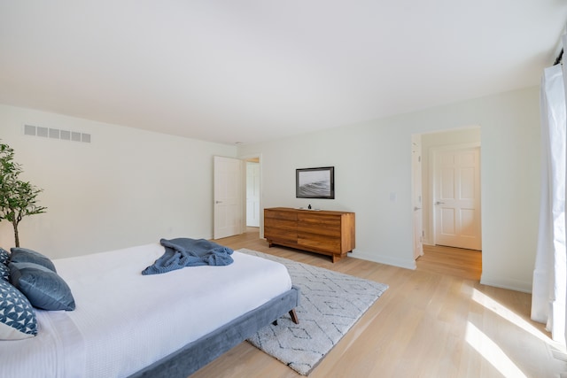 bedroom featuring light wood-type flooring and baseboards