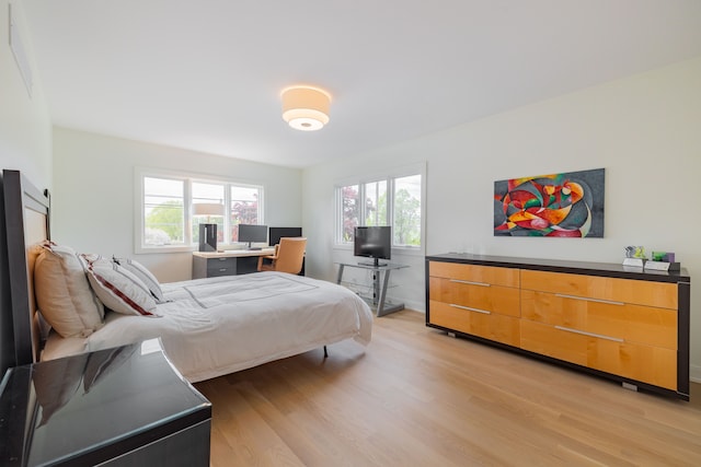 bedroom featuring light wood-type flooring and baseboards