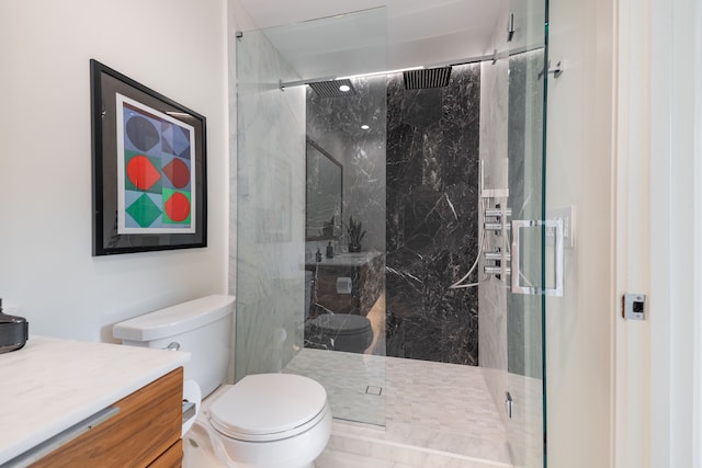 full bathroom with a marble finish shower, toilet, and vanity
