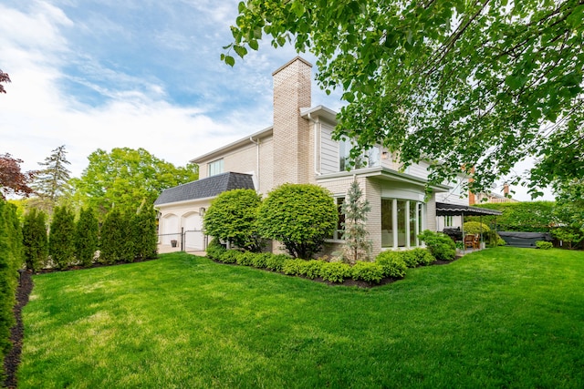 view of green lawn featuring a hot tub