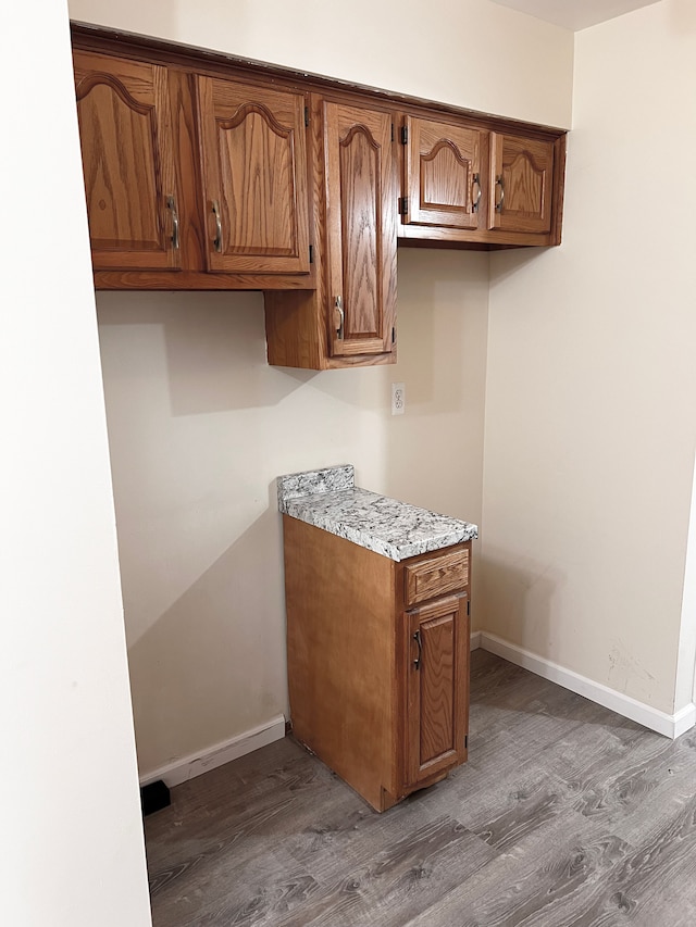 25954 Salem Unit 5, Roseville, MI 48066 - kitchen with brown cabinetry, light countertops, baseboards, and wood finished floors