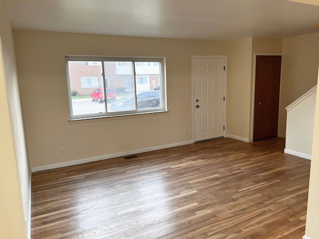 25954 Salem Unit 5, Roseville, MI 48066 - spare room with baseboards, visible vents, and wood finished floors