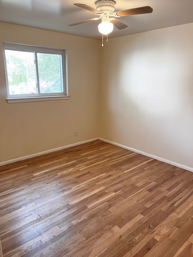 25954 Salem Unit 5, Roseville, MI 48066 - spare room featuring baseboards, a ceiling fan, and wood finished floors