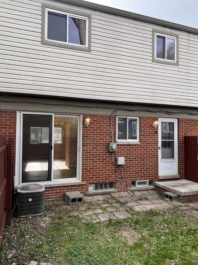 25954 Salem Unit 5, Roseville, MI 48066 - rear view of property featuring brick siding, central AC, and fence