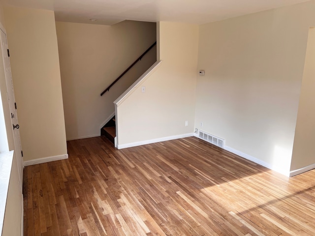 25954 Salem Unit 5, Roseville, MI 48066 - unfurnished living room featuring stairway, baseboards, wood finished floors, and visible vents