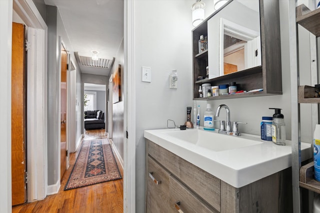 bar featuring a sink and light wood-style flooring