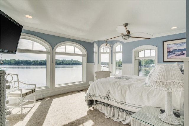 bedroom with crown molding, visible vents, wainscoting, recessed lighting, and carpet