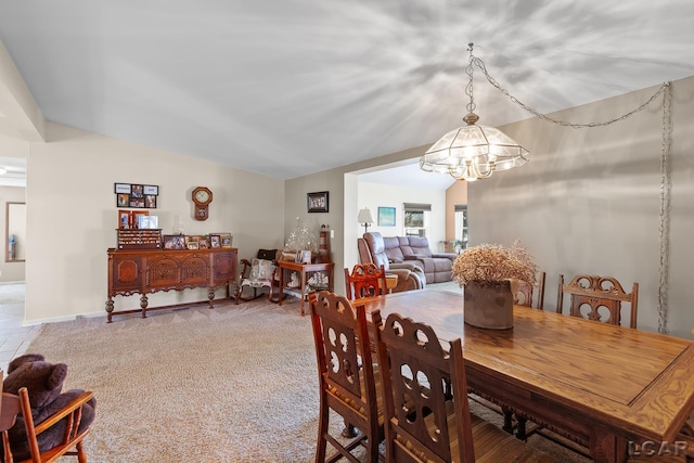 dining room featuring an inviting chandelier and vaulted ceiling