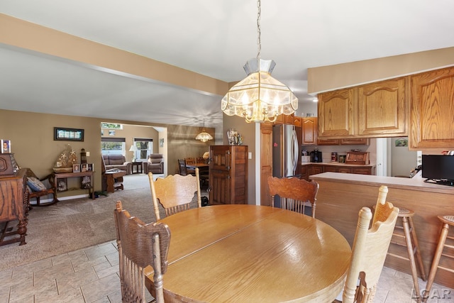 dining area featuring an inviting chandelier and stone finish floor