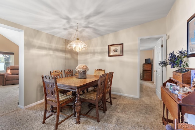 carpeted dining room with baseboards and a notable chandelier