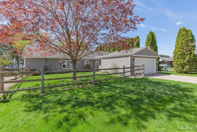 ranch-style house with concrete driveway, fence, and a front yard