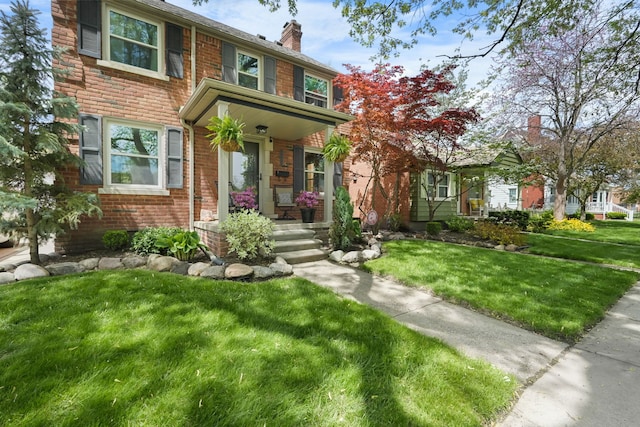 1732 14th St, Wyandotte, MI 48192 - view of front of home featuring brick siding, a chimney, and a front lawn