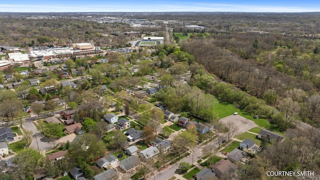 bird's eye view featuring a residential view and a wooded view