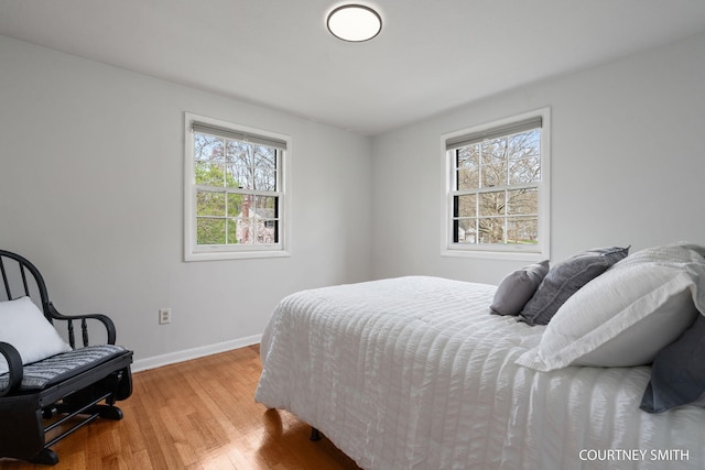 bedroom featuring baseboards and wood finished floors