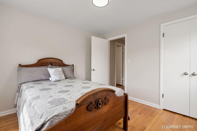bedroom with light wood-style floors and baseboards