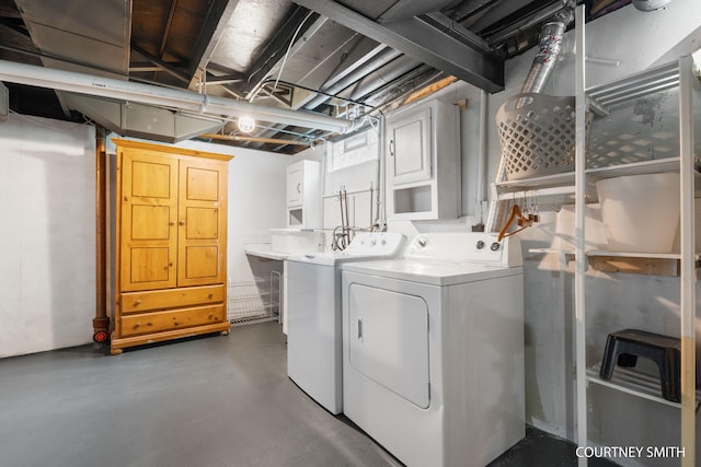 laundry room with cabinet space and washing machine and dryer