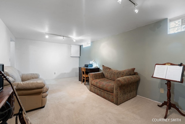 carpeted living room with rail lighting