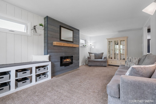 living room with carpet and a fireplace
