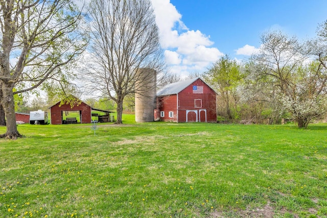 view of yard with a barn, a garage, and an outdoor structure