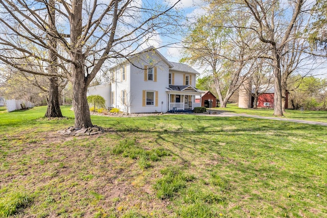 view of front of property with a porch and a front lawn