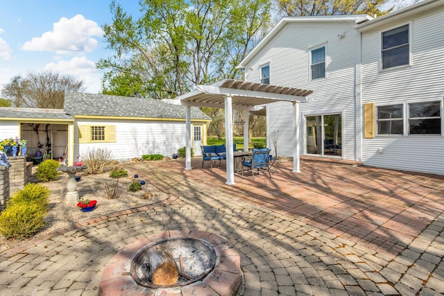 back of house featuring a pergola, a patio area, and an outdoor living space with a fire pit