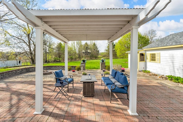 view of patio with an outdoor living space with a fire pit