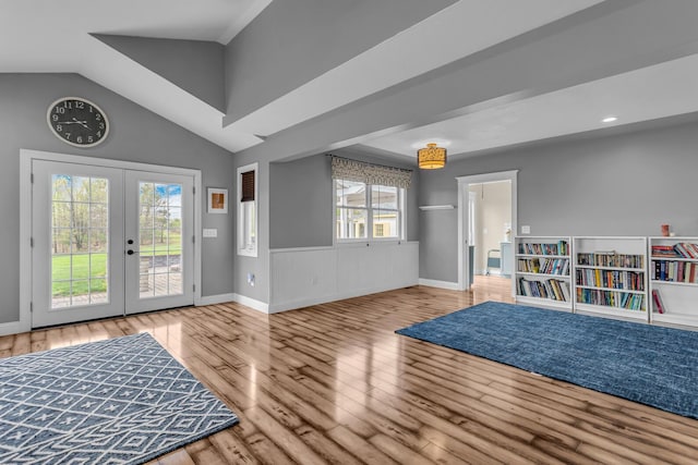 foyer with baseboards, vaulted ceiling, french doors, and wood finished floors