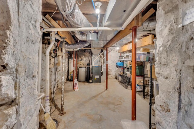unfinished basement featuring heating unit