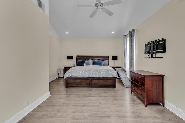 bedroom with baseboards, visible vents, lofted ceiling, and light wood-style floors