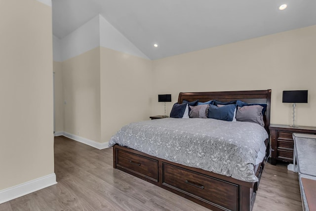 bedroom featuring light wood-type flooring, recessed lighting, baseboards, and lofted ceiling