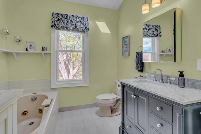 bathroom featuring toilet, baseboards, a tub with jets, and vanity