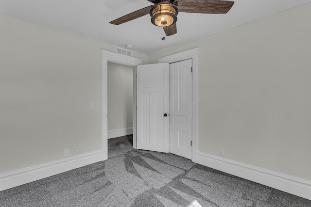 unfurnished bedroom with carpet floors, a ceiling fan, baseboards, and visible vents